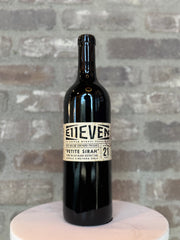 Bottle of wine with a label on a gray surface