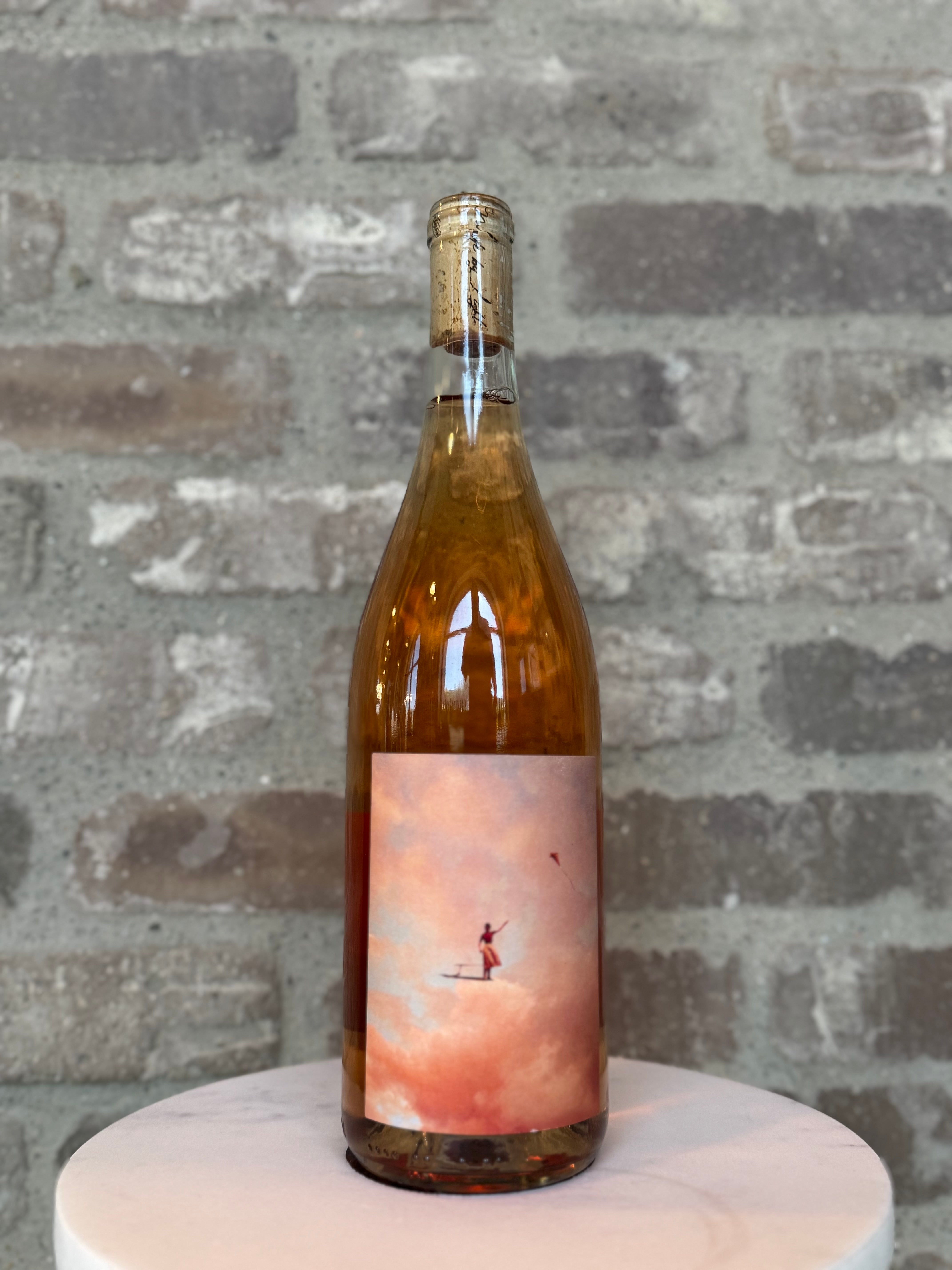 Wine bottle with a scenic label on a gray stone surface