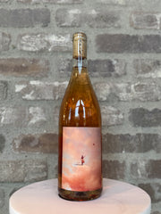 Wine bottle with a scenic label on a gray stone surface