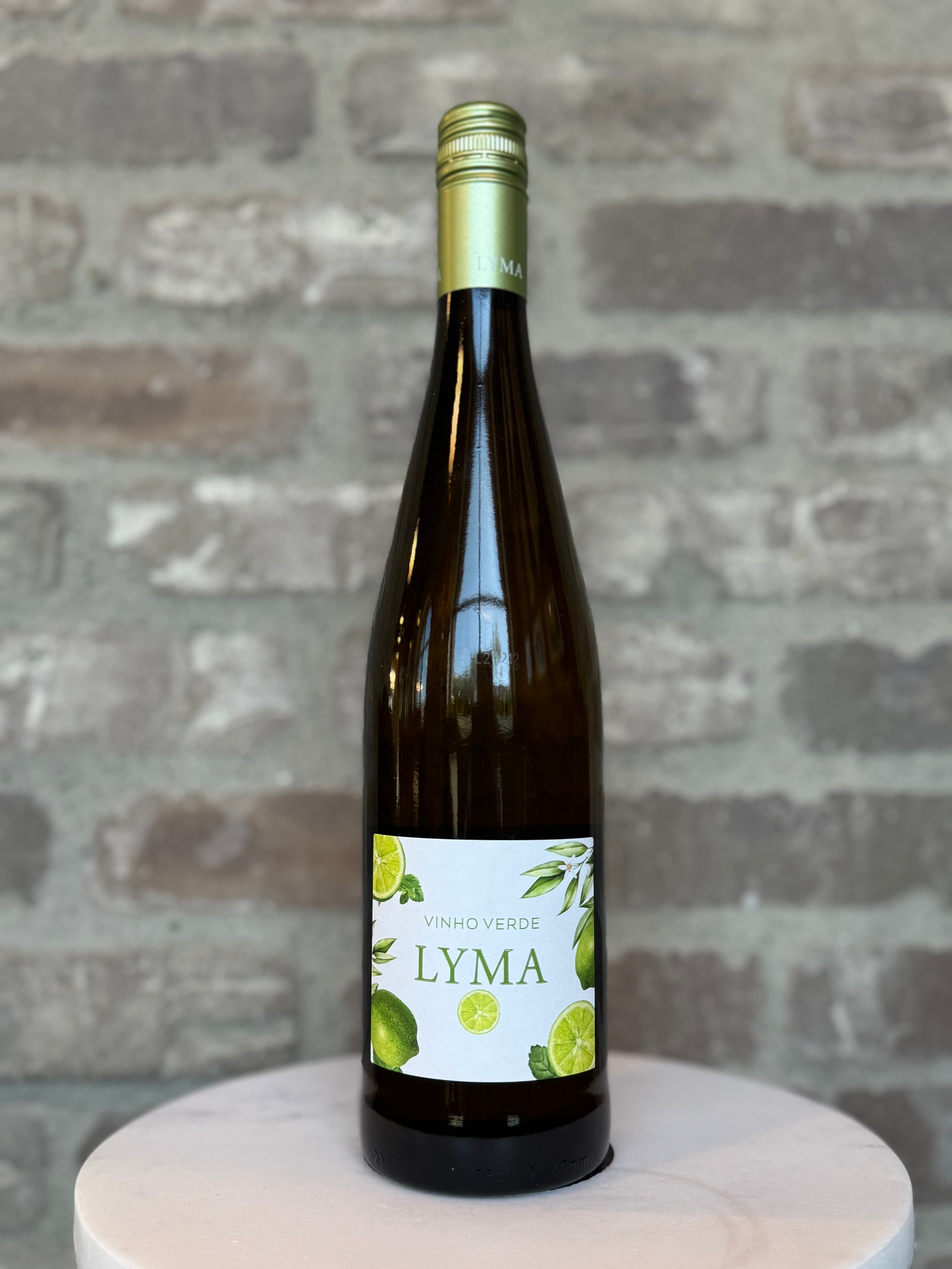 Bottle of Lyma wine on a wooden stand with a stone wall background