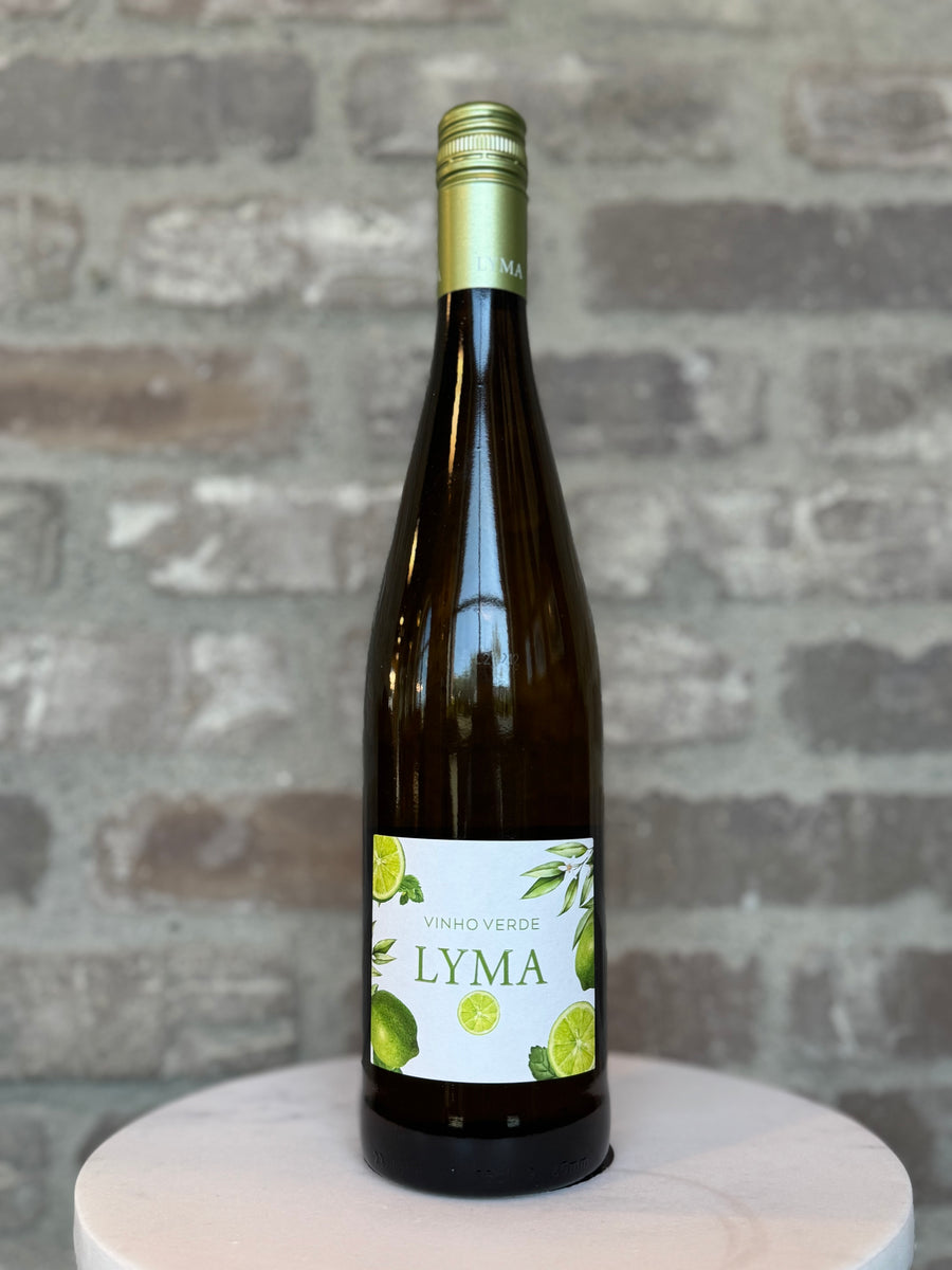 Bottle of Lyma wine on a wooden stand with a stone wall background