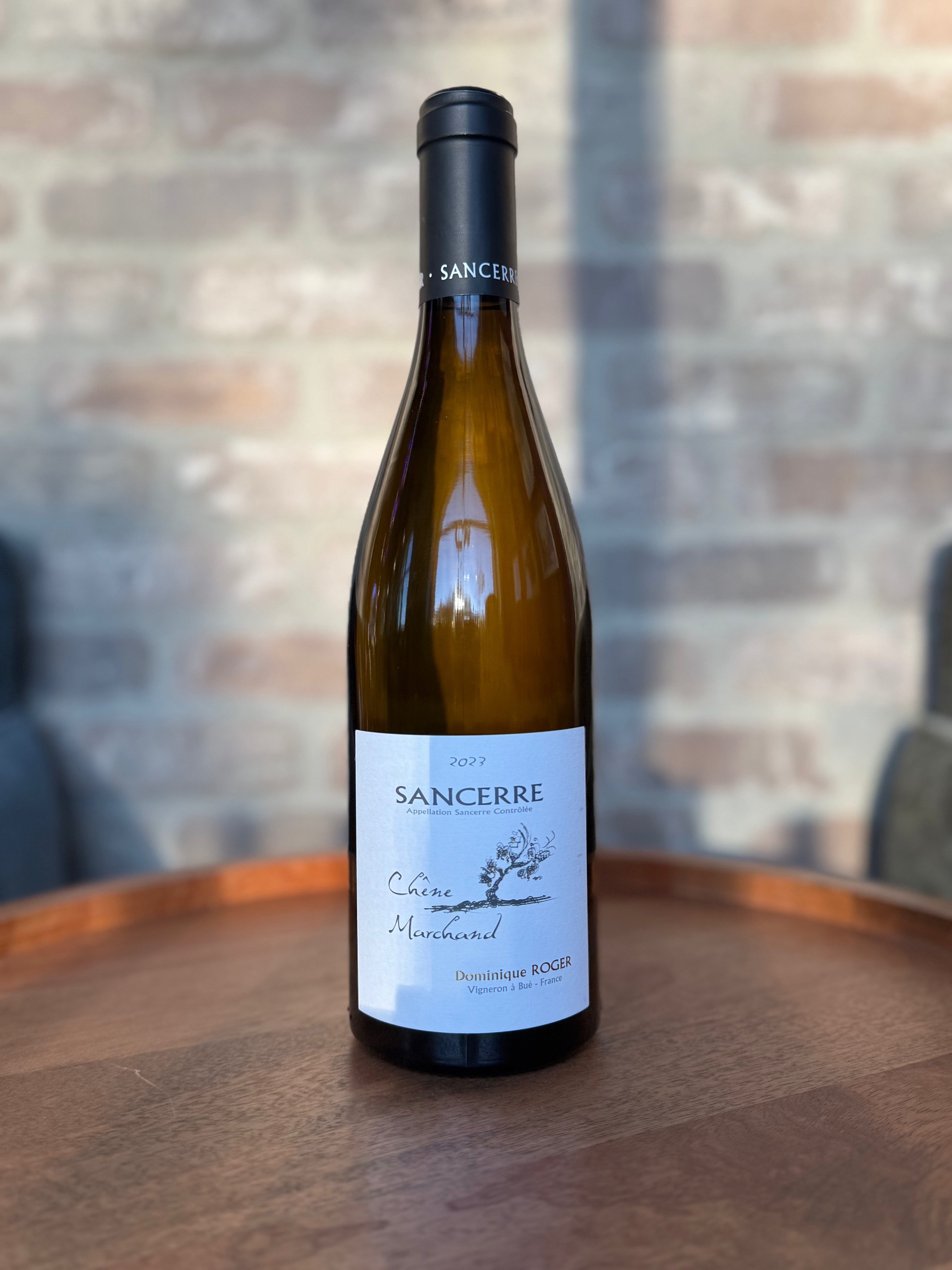 Wine bottle labeled 'Sancerre' on a wooden surface with a blurred background