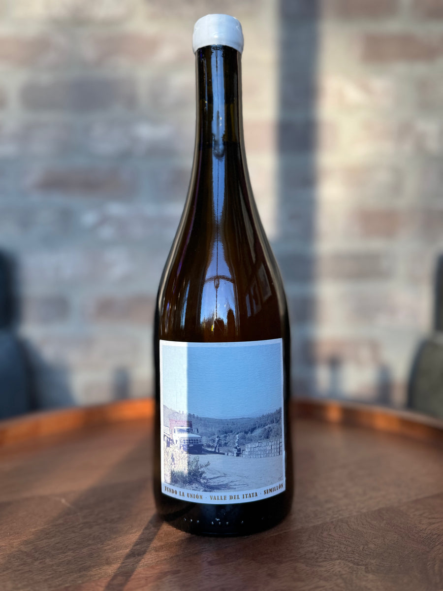 Wine bottle with a label on a wooden surface