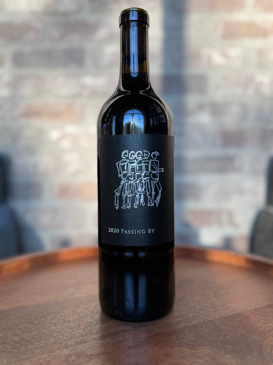 Wine bottle with a black label on a wooden surface