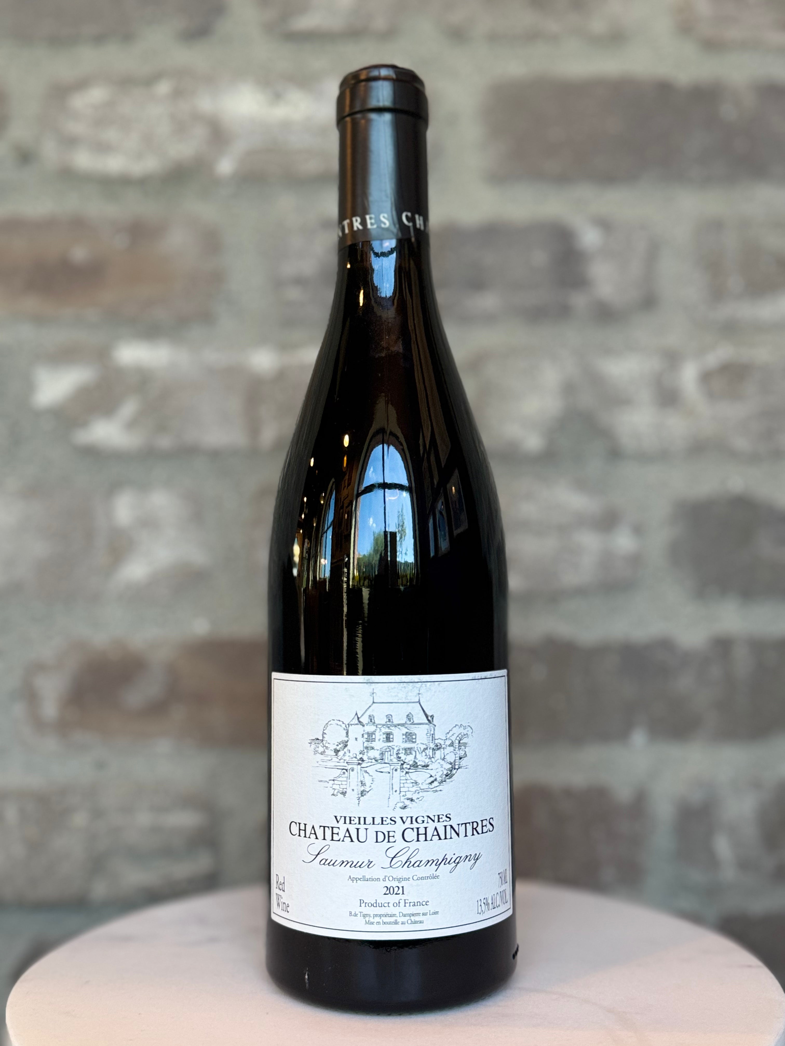 Wine bottle with a label on a stone surface and stone wall background