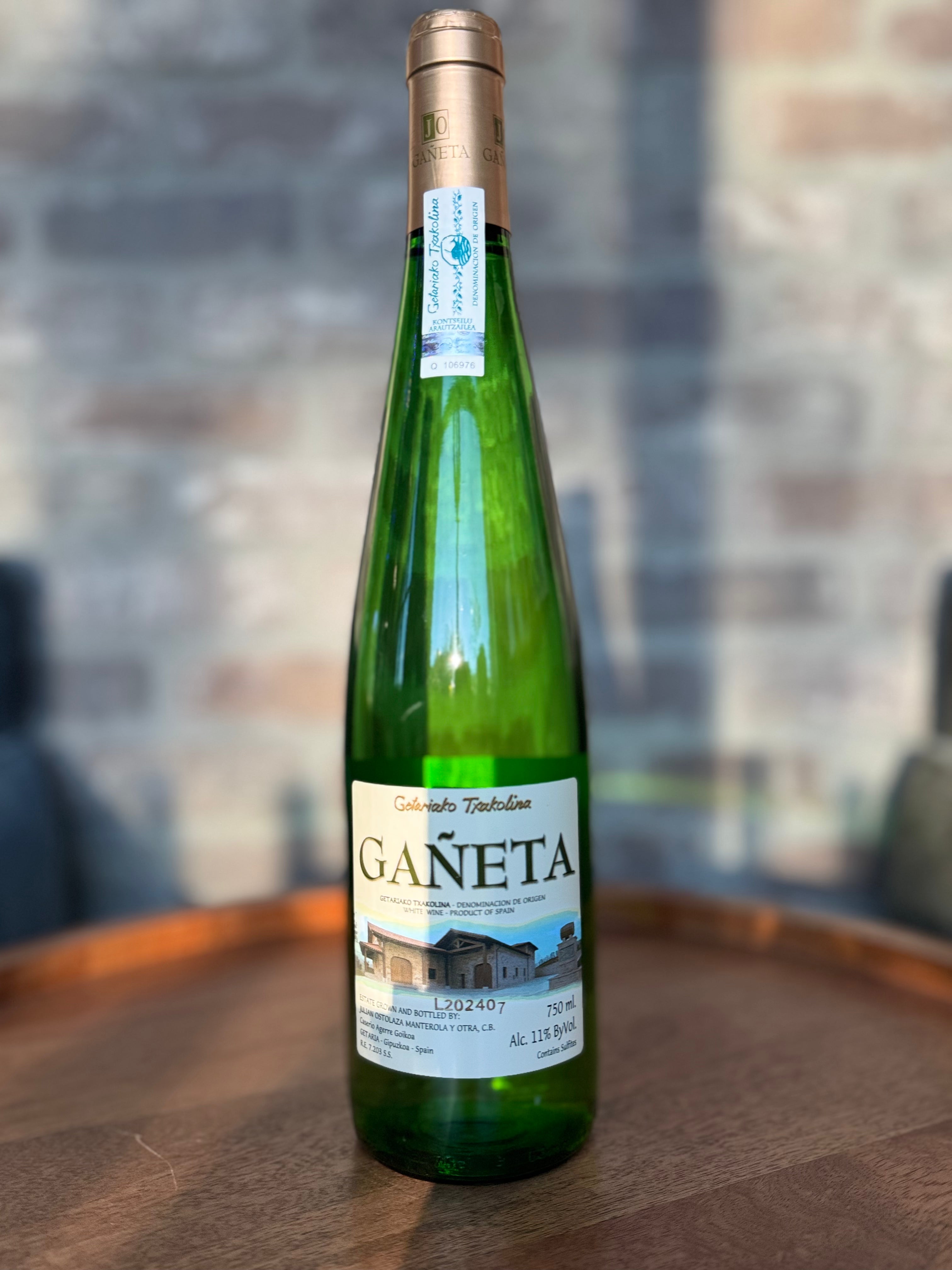 Green wine bottle with a label on a wooden surface