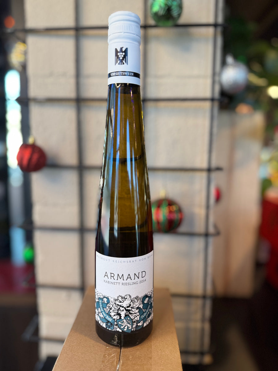 Bottle of Armand wine on a wooden surface with a blurred background