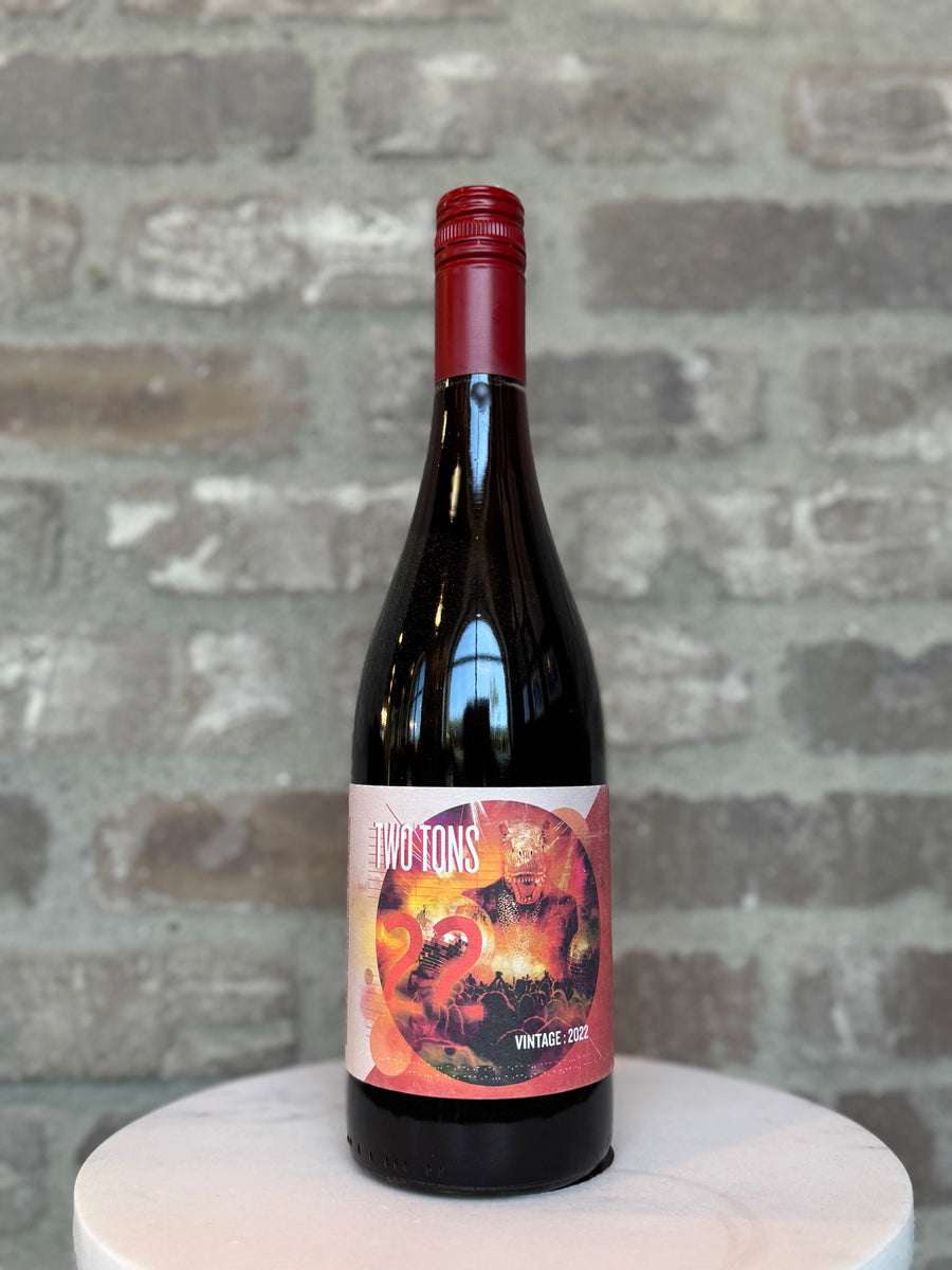 Wine bottle with a colorful label on a gray stone surface