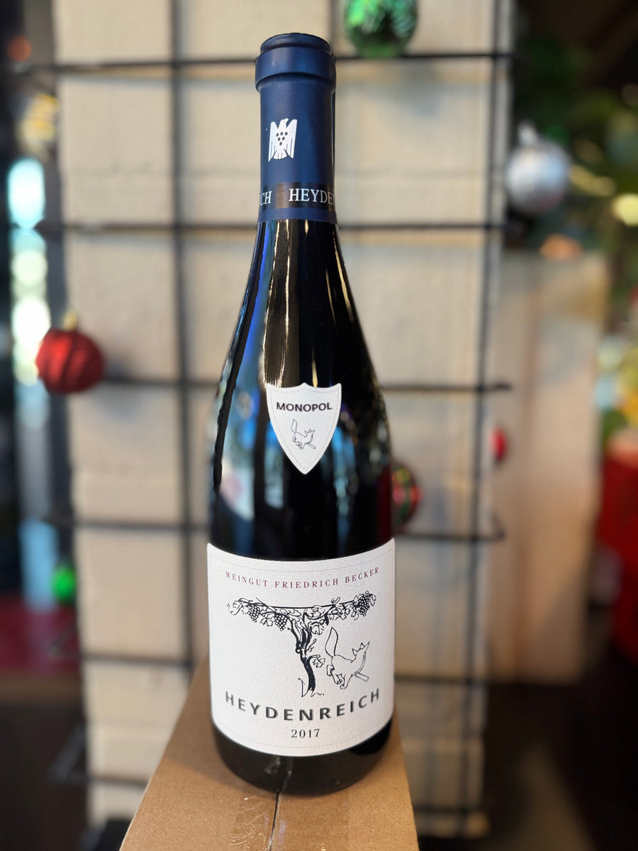 Wine bottle with a blue label on a wooden surface, blurred background