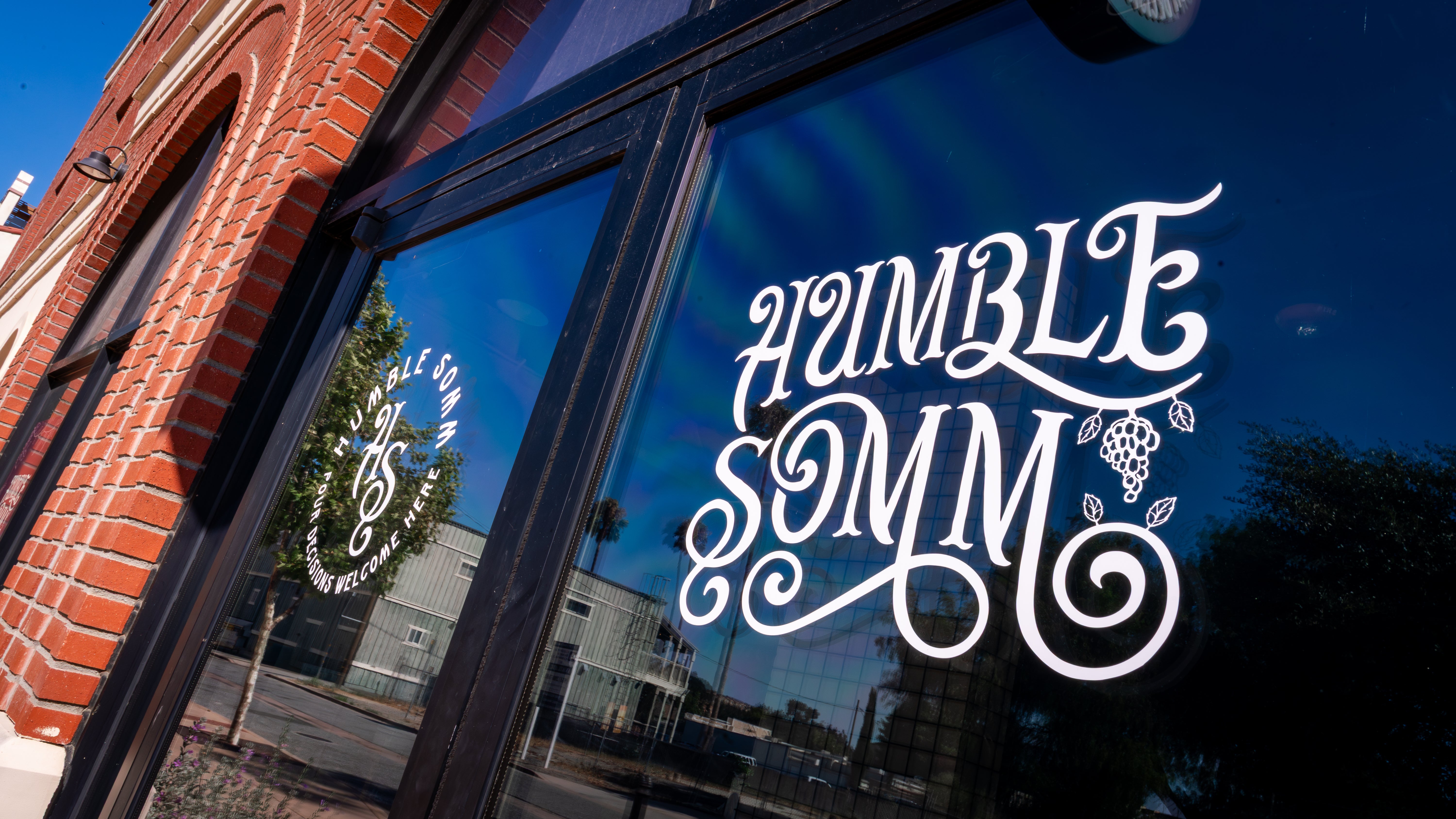 Storefront with 'Humble Somm' logo on a glass window
