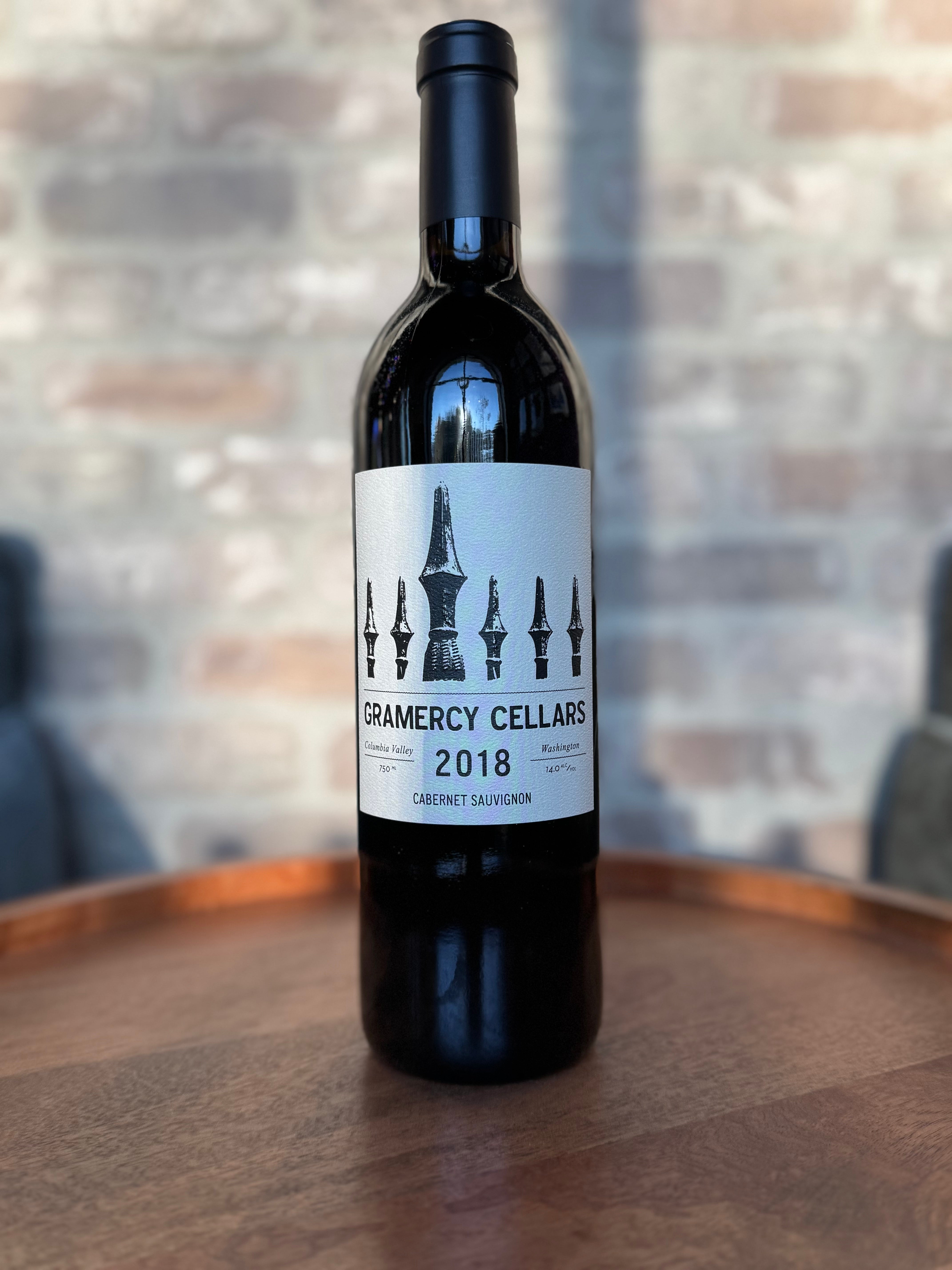 Wine bottle with Gramercy Cellars label on a wooden surface