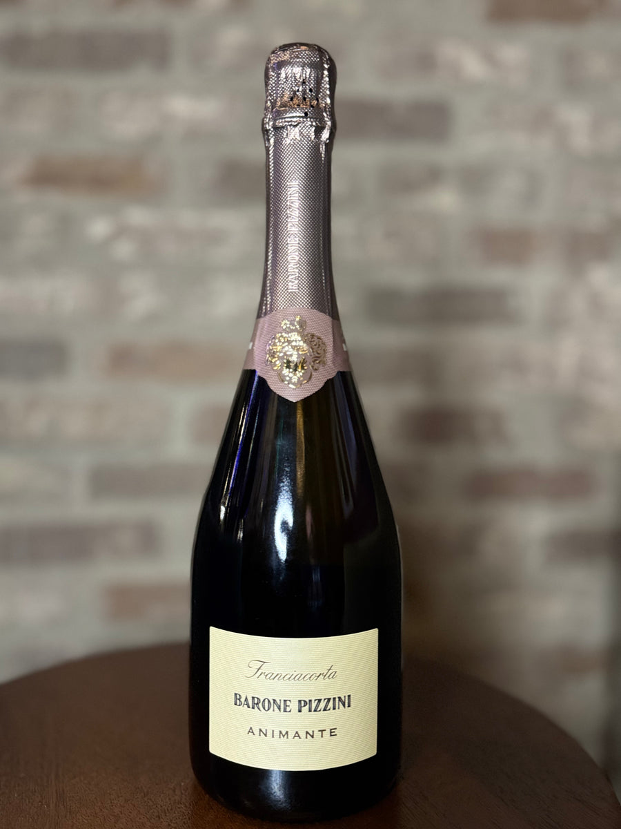 Bottle of Barone Pizzini Animante wine against a brick wall background