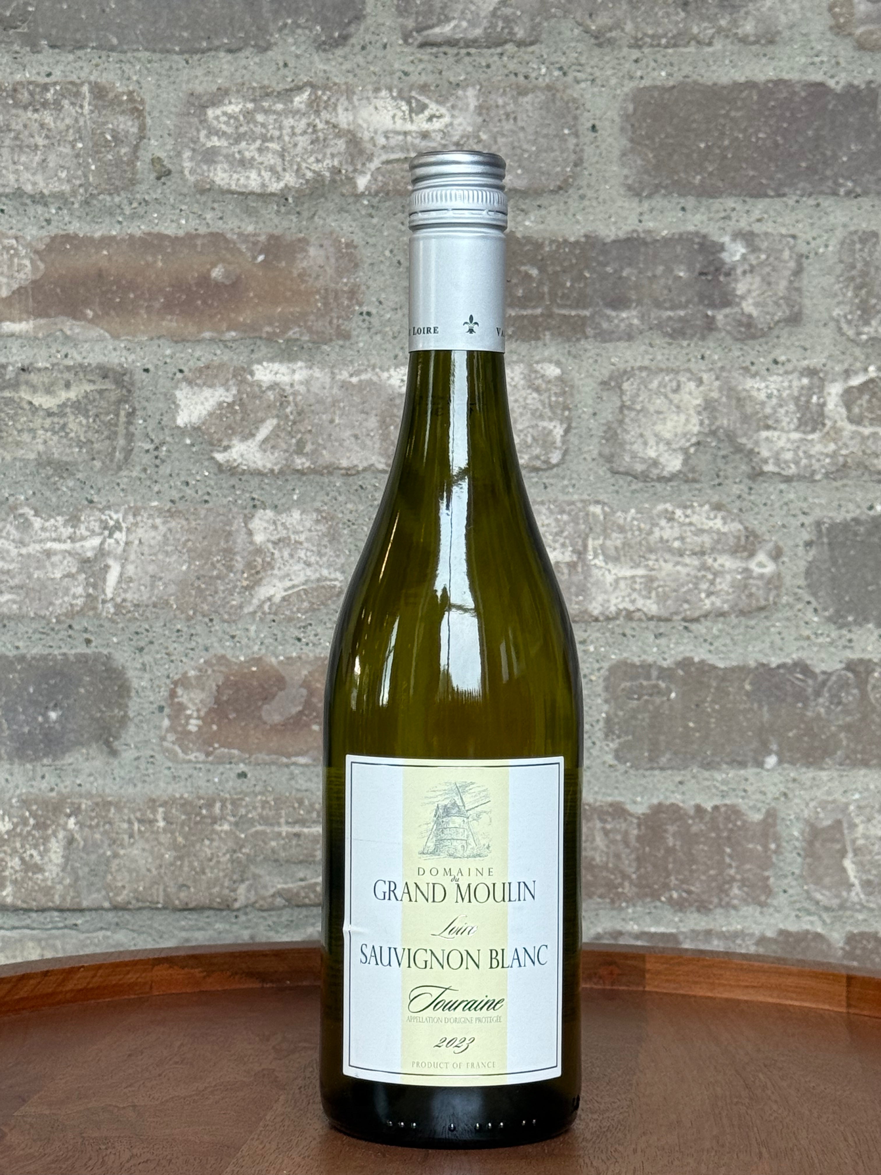 Wine bottle with label against a stone wall background
