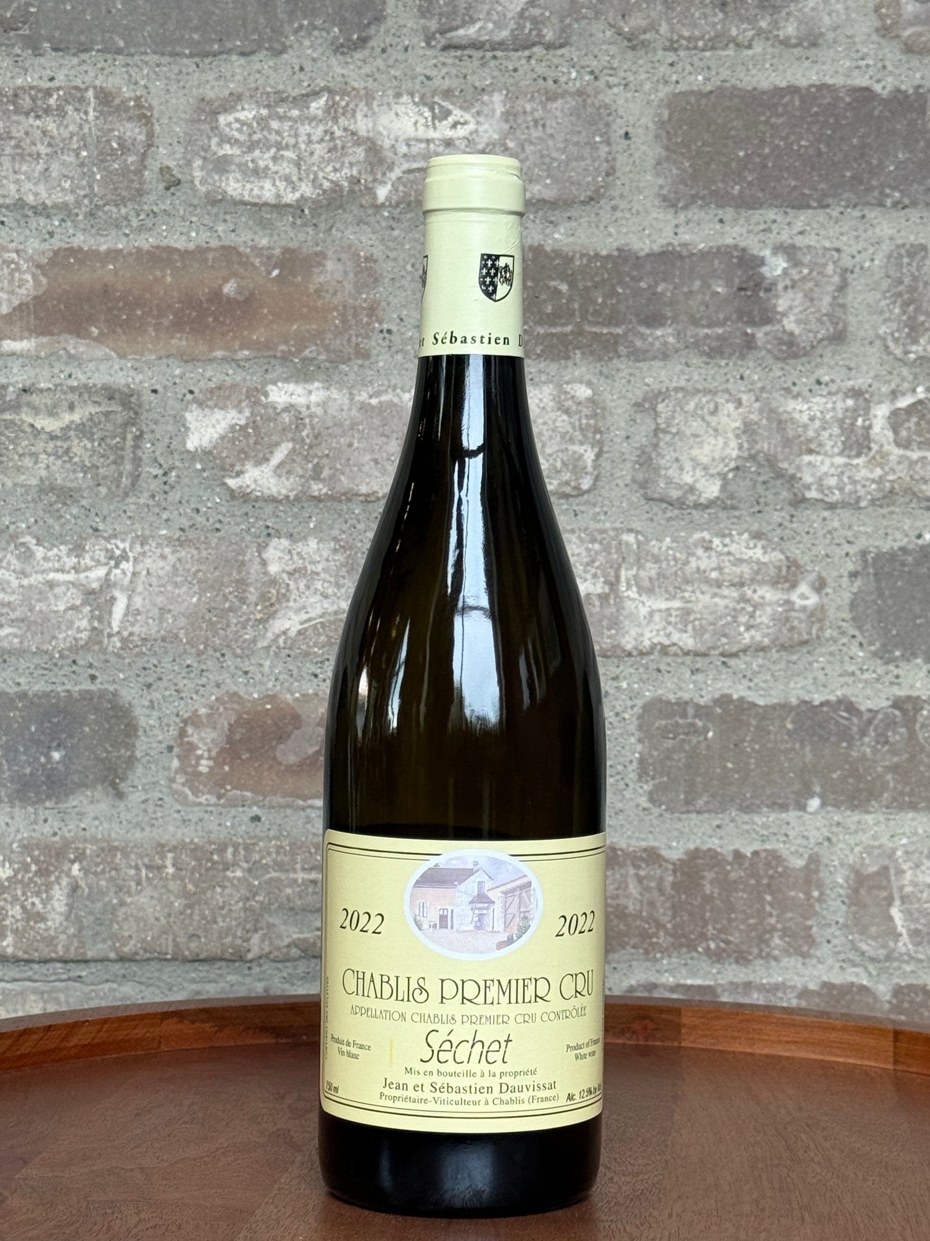 Wine bottle with a label on a wooden surface and stone wall background