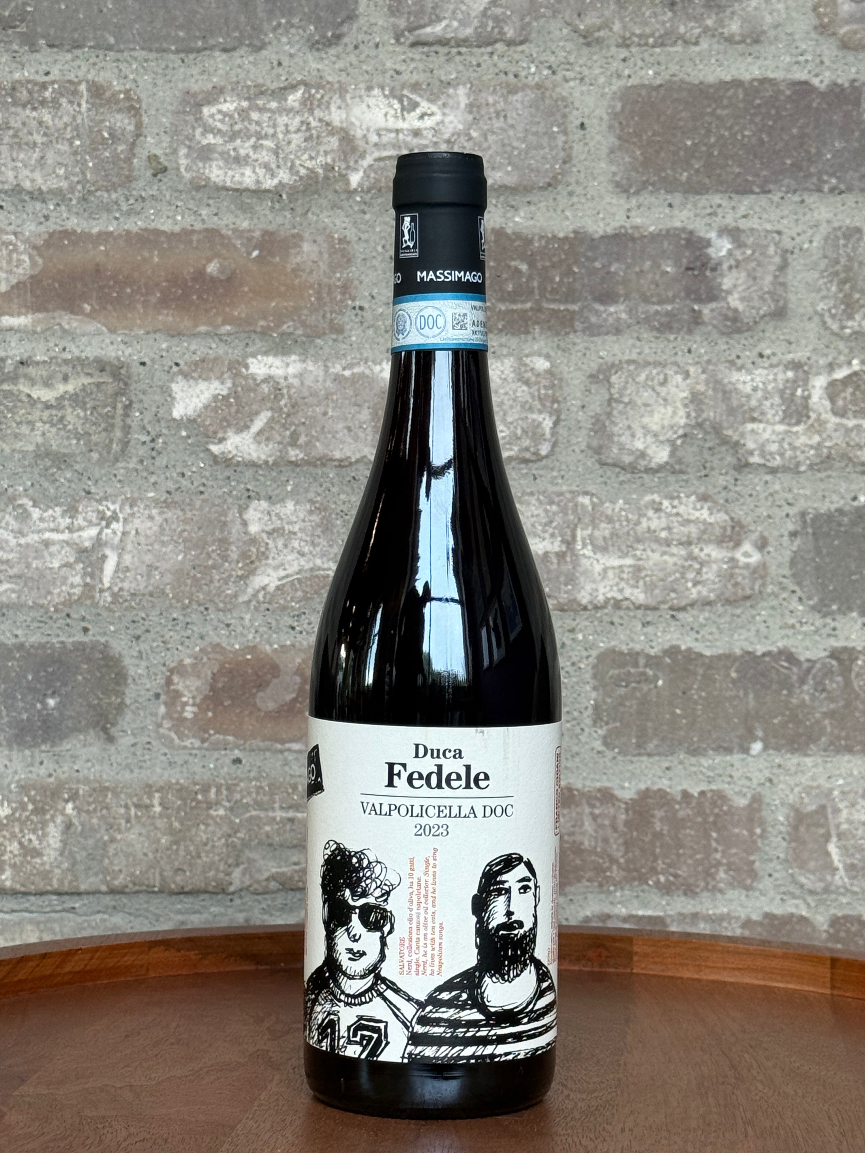 Wine bottle labeled 'Duca Fedele' on a wooden surface with a stone wall background