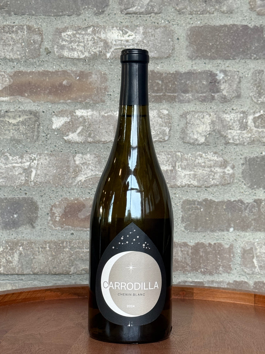 Wine bottle with 'Carrodilla' label against a stone wall background