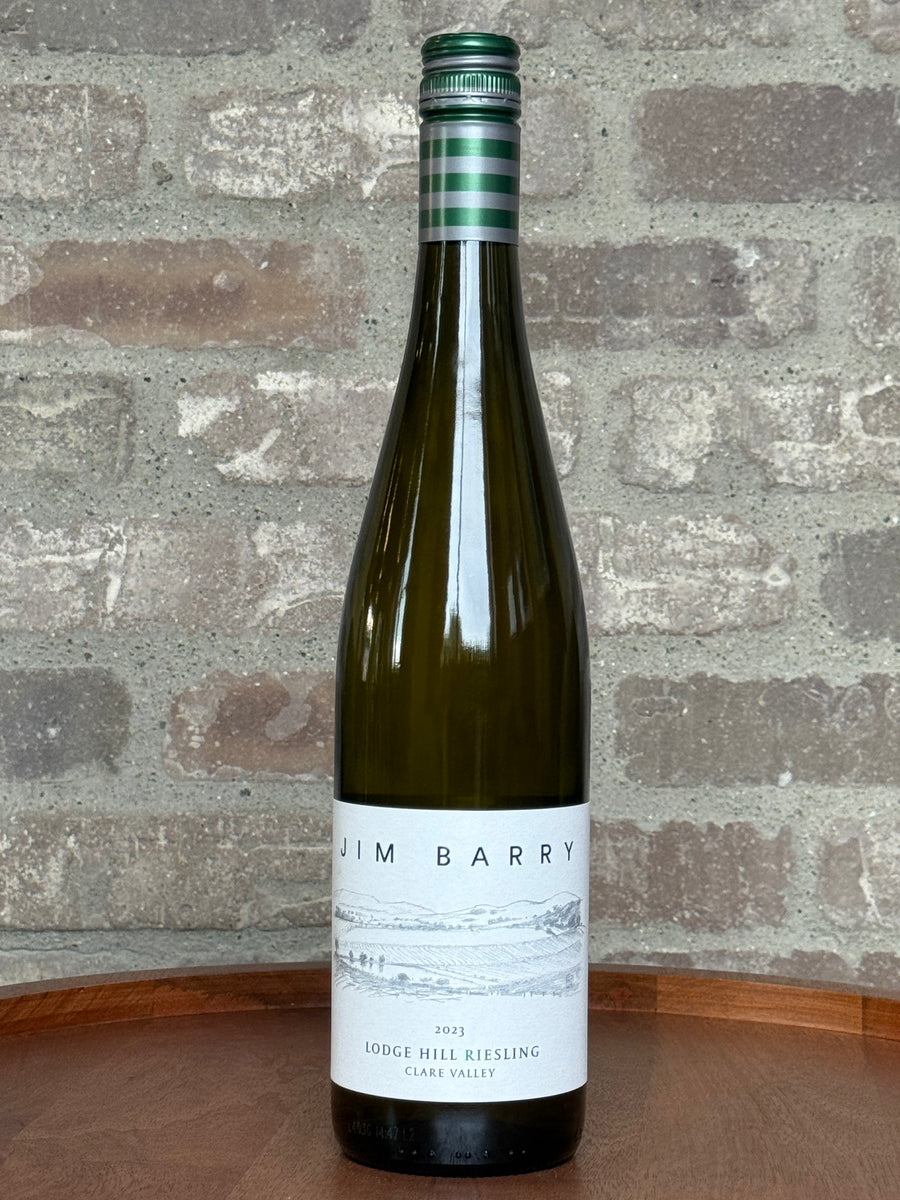 Wine bottle with 'Jim Barry' label against a brick wall background