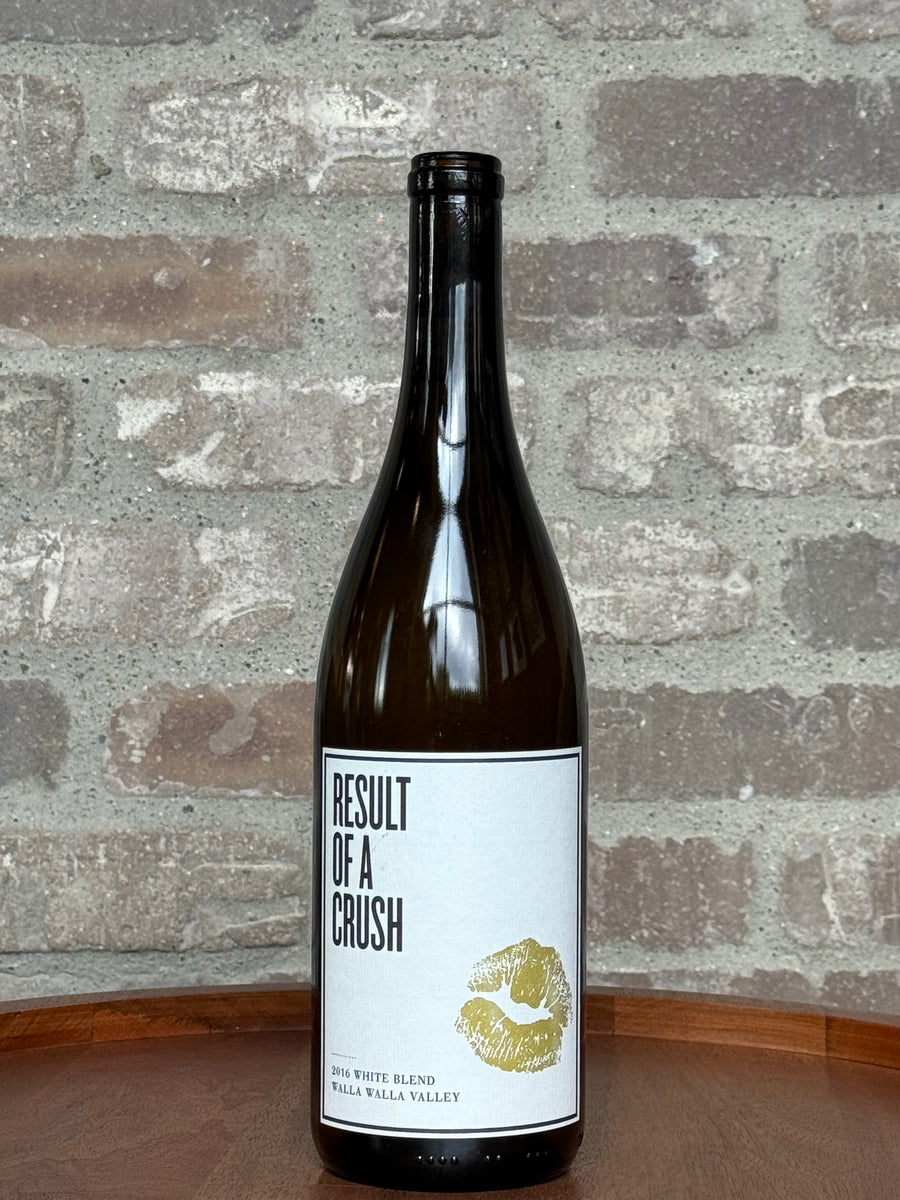 Wine bottle with a label titled 'Result of a Crush' against a brick wall background