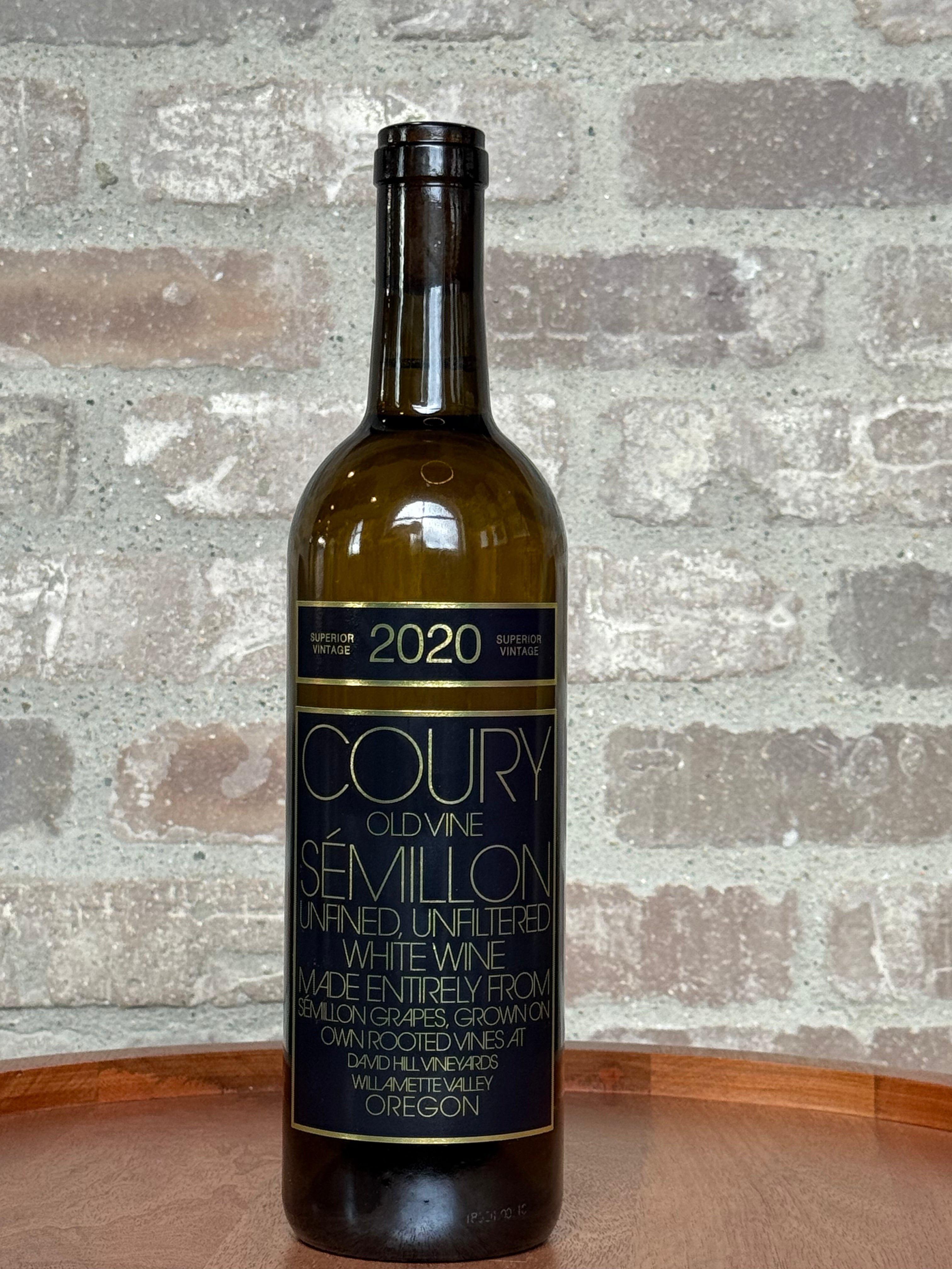Wine bottle with 'Coury' label on a textured stone background