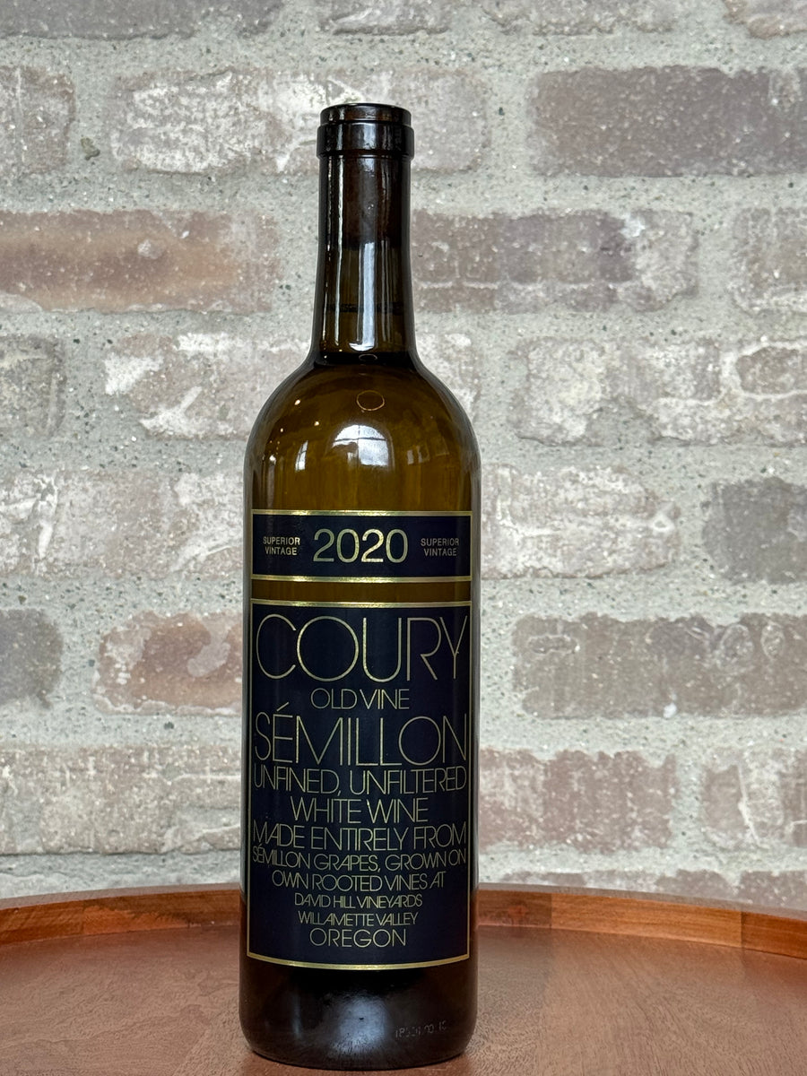 Wine bottle with 'Coury' label on a textured stone background