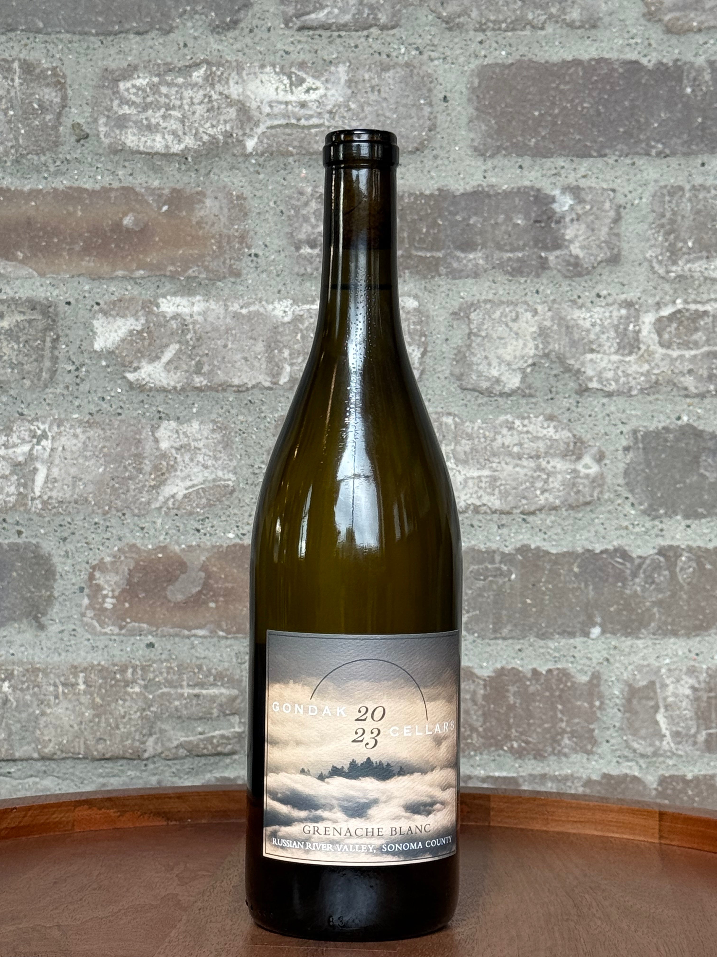 Wine bottle with a label on a wooden surface and brick wall background