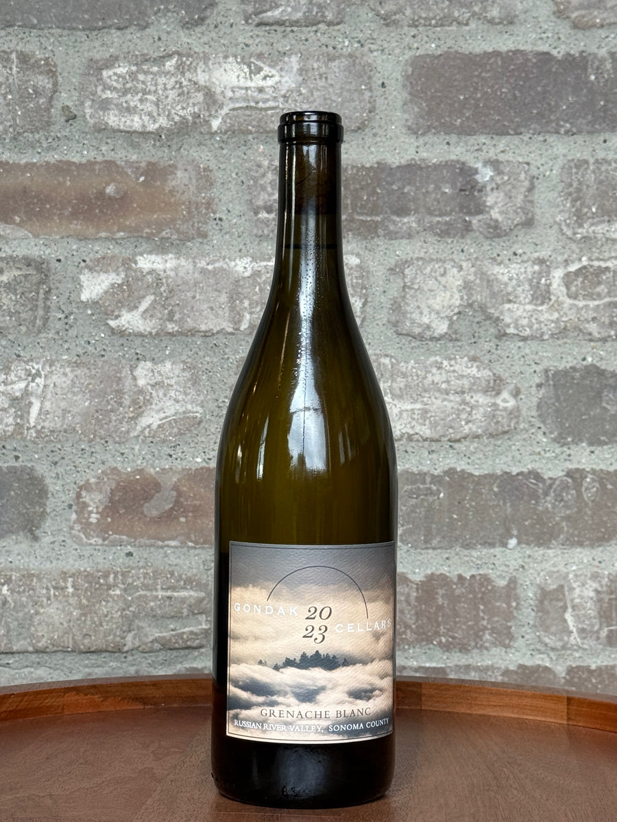 Wine bottle with a label on a wooden surface and brick wall background